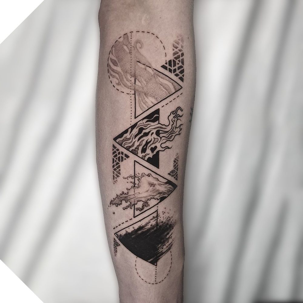 Black ink tattoo on an arm featuring four stacked triangles with elemental patterns.